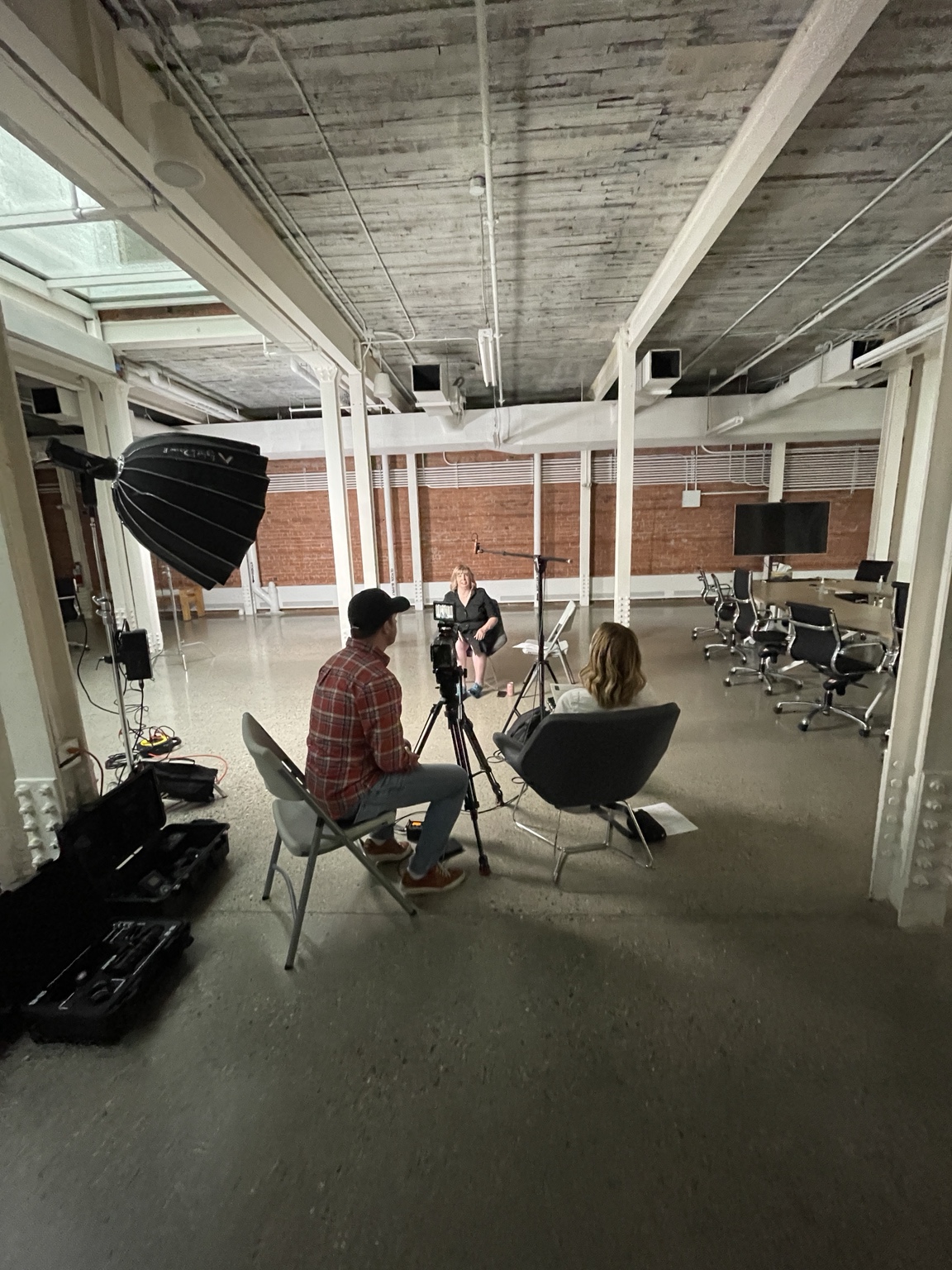 A camera and lighting setup during a filming session in a studio