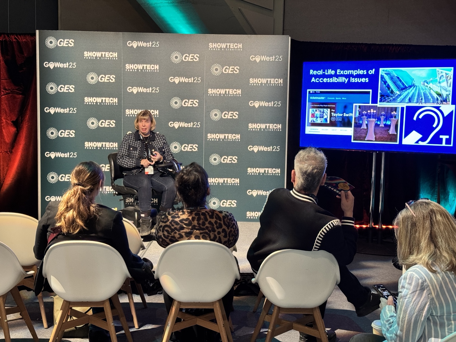 Darby presenting real examples of accessibility issues to an audience at GO West 2025